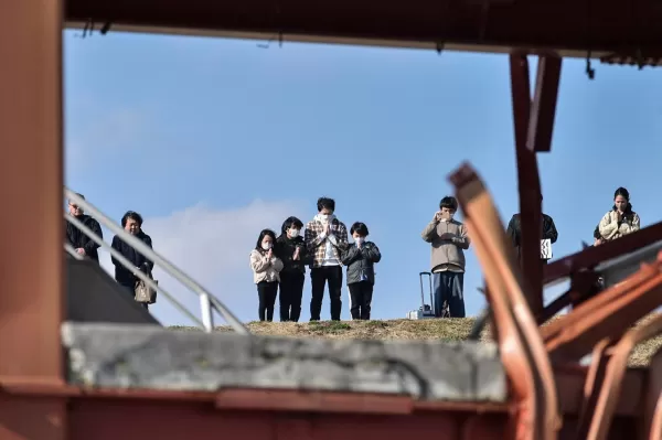 People observing moment of silence on anniversary of 2011 disaster